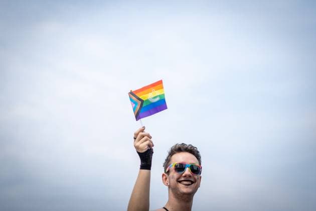August 6, 2023, VANCOUVER, BC, CANADA: A person is seen waving a pride flag during the Pride Parade at English Bay in Vancouver, B.C., Sunday, Aug. 6, 2023. VANCOUVER CANADA  - ZUMAc35_ 20230806_zaf_c35_007 Copyright: xEthanxCairnsx