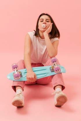 Creative Highlights Symbolbilder Mädchen kaut Kaugummi und hält ein Skateboard *** Girls chews Chewing gum and holds a Skateboard Copyright: imageBROKER/OleksandrxLatkun ibxole09460156.jpg ,model released, Symbolfoto ,property released