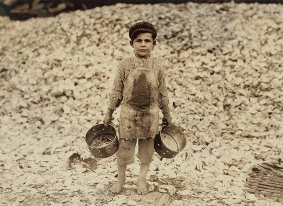 5-year-old Boy working as Shrimp Picker standing on Large Mound of Oyster Shells, Biloxi, Mississippi, USA, Lewis Hine, 1911  Copyright: xCircaxImagesx ghi-circa01192
