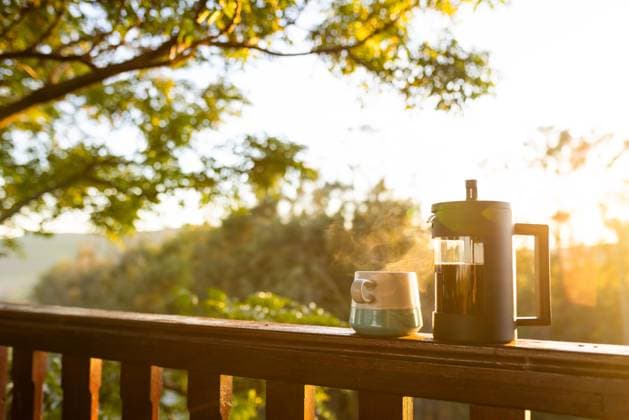 Balcony of log cabin with coffee press and coffee mug on sunny day. Nature, agriculture, summer, tranquillity and drink. Copyright: xx 4106692