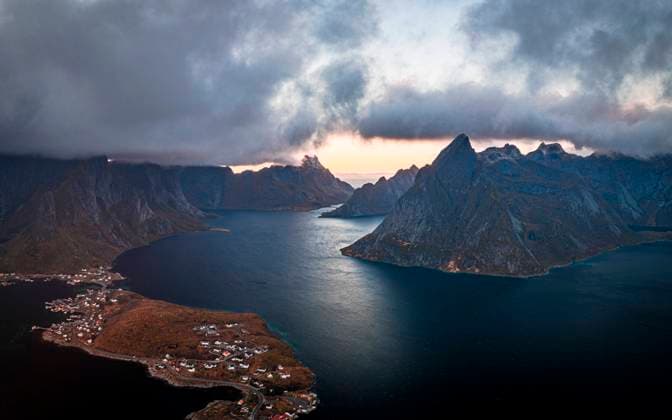 Storm clouds at sunset over majestic mountains along a fjord, aerial view, Reine Bay, Lofoten Islands, Nordland, Norway, Scandinavia, Europe Copyright: RobertoxMoiola 1179-6323 RECORD DATE NOT STATED
