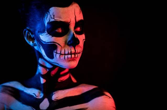 Pretty woman with skeleton tattoo Isolated on black, closeup picture, toned red and blue, attractive young brunette caucasian woman with scull body art, wide opened grey eyes ,model released, Symbolfoto Copyright: xZoonar.com IvanxTraimakx 11382741 ,model released, Symbolfoto ,property released