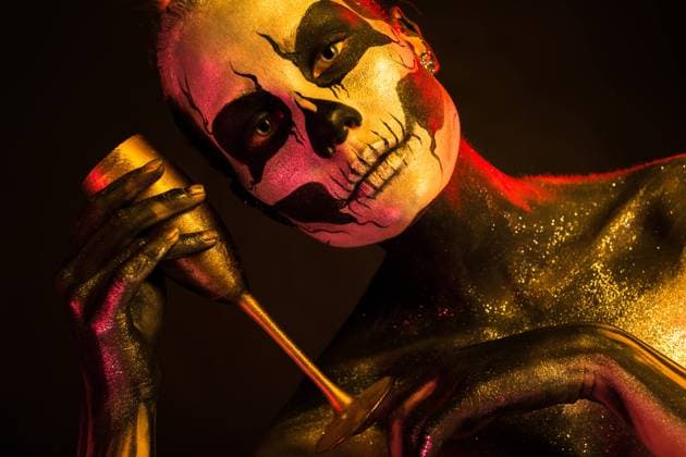 Pretty girl with skeleton makeup holds glass Isolated on black, closeup picture, toned red and yellow, beautiful young blonde caucasian woman with scull body art with wine glass in hand, grey eyes, makes toast ,model released, Symbolfoto Copyright: xZoonar.com IvanxTraimakx 11382783 ,model released, Symbolfoto ,property released