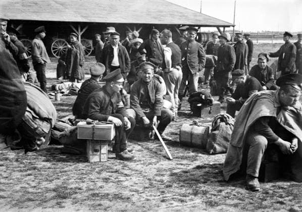 Prisoners resting on their luggage while awaiting order to move to repatriation points, Lamsdorf, Germany, American Red Cross Collection, June 7, 1919  Copyright: xCircaxImagesx ghi-circa11773