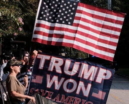 August 24, 2023, Atlanta, Georgia, USA: Two supporters of former President Donald Trump hold flags as a large crowd of Trump supporters rallied at the Fulton County Jail in Atlanta where the former president was to turn himself in after being indicted on charges related attempting to overturn the results of the 2020 presidential election, which he lost to Joe Biden. Atlanta USA - ZUMAb165 20230824_znp_b165_005 Copyright: xJohnxArthurxBrownx