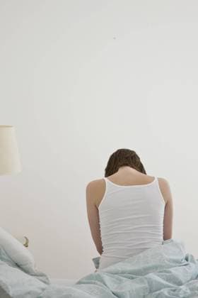 Portrait of the back of a woman sitting on bed  Copyright: Ableimages fStopImages2035146 ,model released, Symbolfoto ,property released