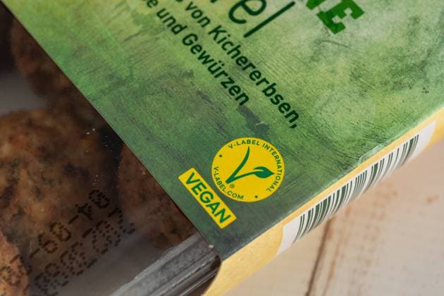 Augsburg, Bavaria, Germany - 29 August 2023: The V Label (European Vegetarian Union) on a package of vegan falafel. Vegan Food Label *** Das V Label (European Vegetarian Union) auf einer Packung veganer Falafel. Kennzeichnung für Vegane Lebensmittel