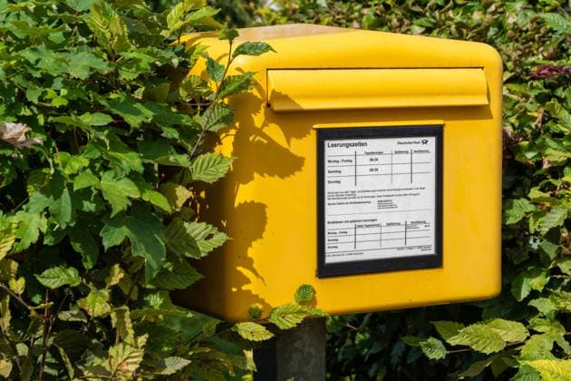 Stettenhofen, Bavaria, Germany - 31 August 2023: A public yellow mailbox from Deutsche Post for sending letters *** Ein öffentlicher gelber Briefkasten von der Deutschen Post zum versenden von Briefen