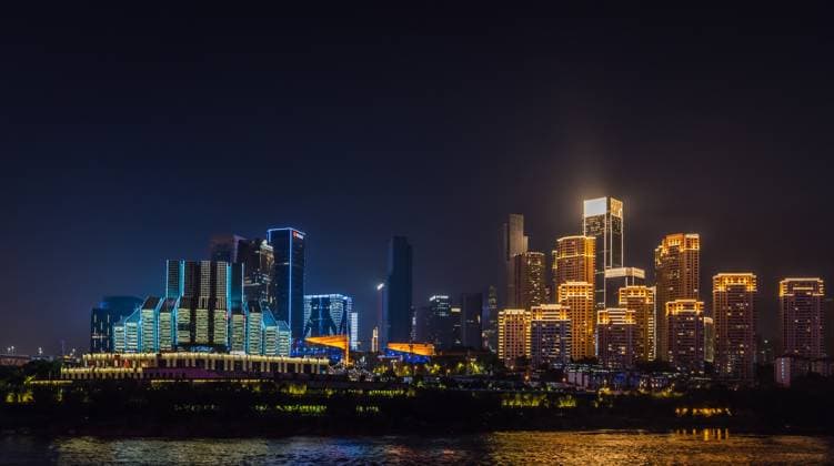 Creative Highlights World Chongqing city skyline at night Chongqing, China - August 2019 : Night view of the Chongqing city lights over Jialing and Yangtze river with illuminated skyscrapers in the background Copyright: xZoonar.com PawelxOpaskax 15411157