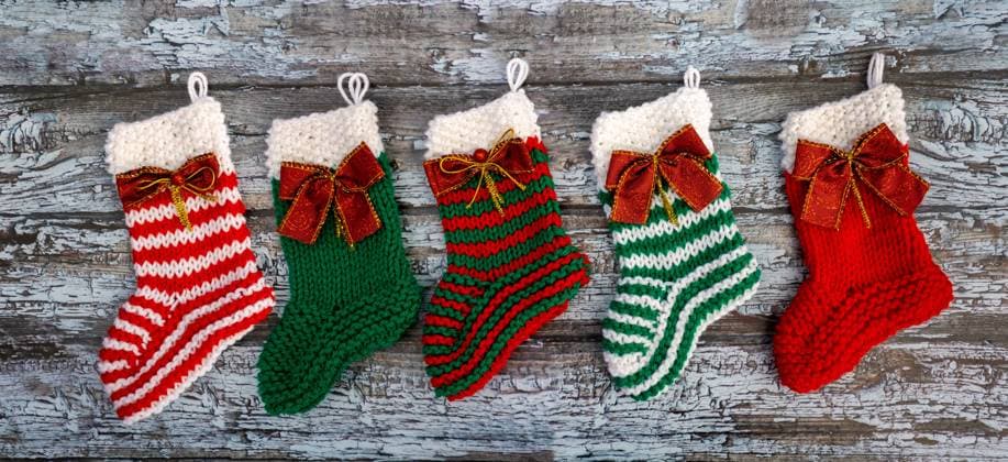 Christmas socks decorated with bows knitted wool christmas socks decorated with bows on rustic background Copyright: xZoonar.com GabrielaxBertolinix 19218054