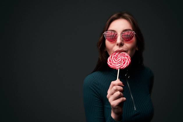 Creative Highlights Symbolfotos Portrait of a young beautiful stylish girl wearing red drop shaped sunglasses holding a red lollipop and biting it in a seductive sexy way isolated on dark grey background Portrait of a young beautiful stylish girl wearing red drop shaped sunglasses holding a red lollipop and biting it in a seductive sexy way ,model released, Symbolfoto Copyright: xZoonar.com OleksandrxBerezkox 15589090 ,model released, Symbolfoto ,property released