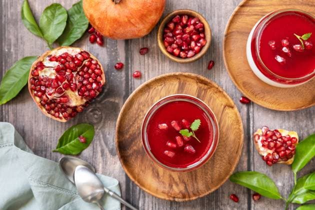 Winter delicious italian dessert panna cotta with pomegranate jelly and mint, homemade cuisine on a wooden background. View from above. Winter delicious italian dessert panna cotta with pomegranate jelly and mint, homemade cuisine on a wooden background. View from above. Copyright: xZoonar.com ELENAxHRAMOVAx 20078977