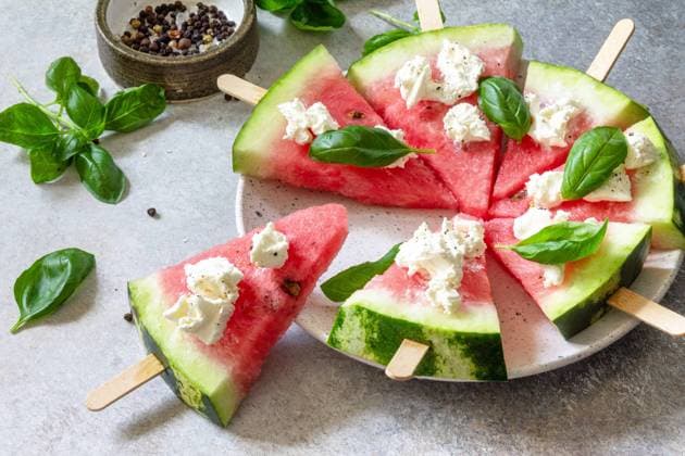 Healthy seasonal dieting and nutrition, summer snack. Watermelon pizza with feta cheese and basil on a gray stone tabletop. Healthy seasonal dieting and nutrition, summer snack. Watermelon pizza with feta cheese and basil on a gray stone tabletop. Copyright: xZoonar.com KHRAMOVAxxELENAx 20144214