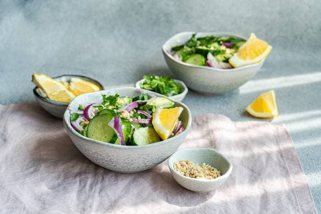Healthy vegetables salads with organic cucumber, red onion, coriander and chopped nuts placed in a concrete table Model Released AnnaBogush_ID16473_500769_005 Copyright: xAnnaxBogushx