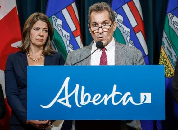 September 15, 2023, Calgary, AB, CANADA: Dr. Mark Joffe, right, Alberta chief medical officer of health, speaks to the media about an E-coli outbreak at several Calgary daycares, as Alberta Premier Danielle Smith looks on in Calgary, Alta., Friday, Sept. 15, 2023. Calgary CANADA - ZUMAc35_ 20230915_zaf_c35_032 Copyright: xJeffxMcintoshx