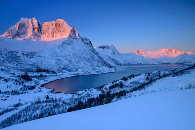 Norway, Troms og Finnmark, Coast of Mefjord at dusk with Breidtind mountain in background, ANSF00499