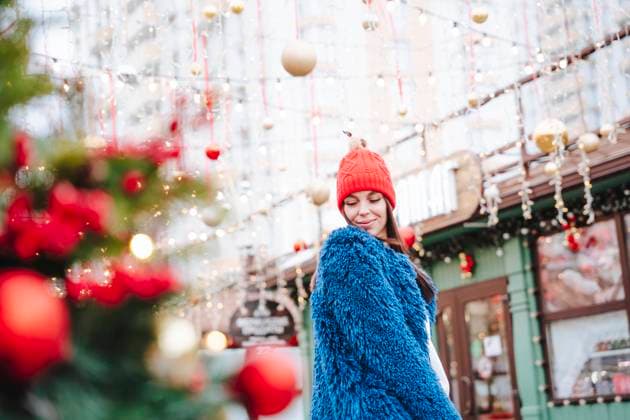 Smiling woman wearing blue coat standing in city model released, Symbolfoto, NLAF00094