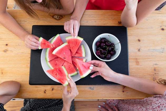 Friends having watermelon and cherries at table model released, Symbolfoto property released, JPTF01287