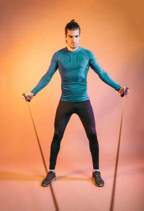 Creative Highlights Symbolbilder Athlete training with resistance band in front of backdrop model released, Symbolfoto, MMPF00865