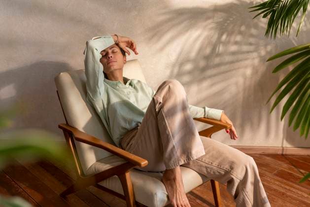 Creative Highlights Symbolbilder Woman with eyes closed sitting in armchair at home model released, Symbolfoto property released, VPIF08631