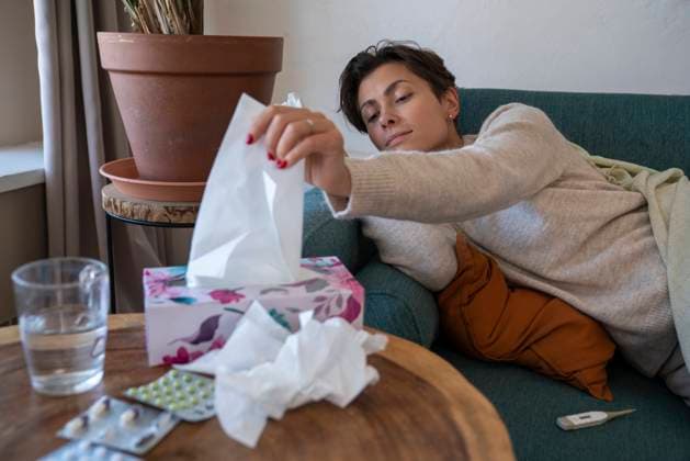 Sick woman taking out tissue from box at home model released, Symbolfoto property released, VPIF08640