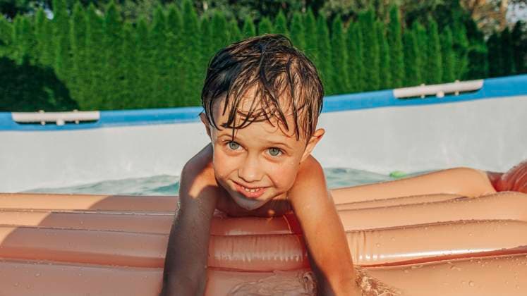 Creative Highlights Symbolbilder Cute boy with swimming float enjoying summer at backyard model released, Symbolfoto, VSNF01380