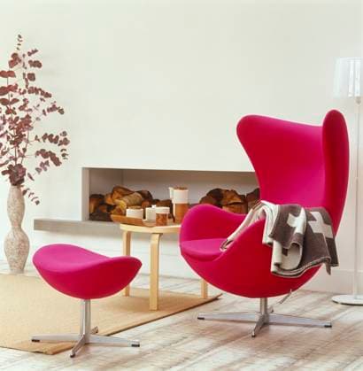Arne Jacobsen pink chair and footstool in front of fireplace in modern sitting r Arne Jacobsen pink chair and footstool in front of fireplace in modern sitting room, Credit:Mel Yates Avalon  Copyright: xMelxYatesx xAvalonx 0512775377