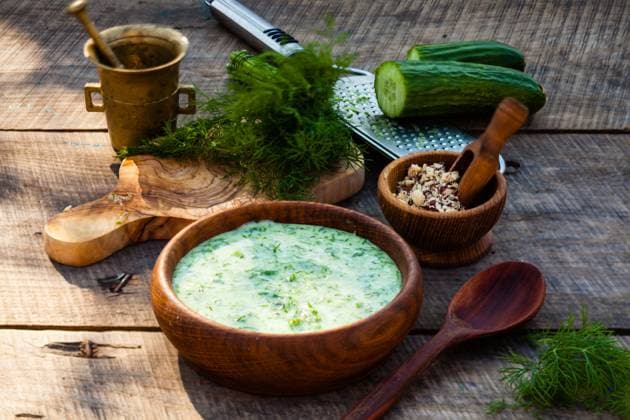 Homemade tarator with ingredients on wooden rustic background Homemade chilled tarator with ingredients on wooden rustic background. Traditional bulgarian summer cold soup with cucumbers, dill, garlic, yogurt and walnuts. ,model released, Symbolfoto Copyright: xZoonar.com OksanaxShufrychx 14398381 ,model released, Symbolfoto ,property released