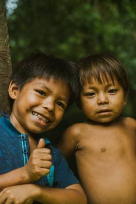MR_ID16184_14961_DanielGualinga.jpg, MR_ID16184_14960_DavidGualinga.jpg Smiling little boy showing thumb up standing with younger brother in village nature Model Released AlvaroMontero_ID16184_492069_015 Copyright: xAlvaroxMonterox RECORD DATE NOT STATED