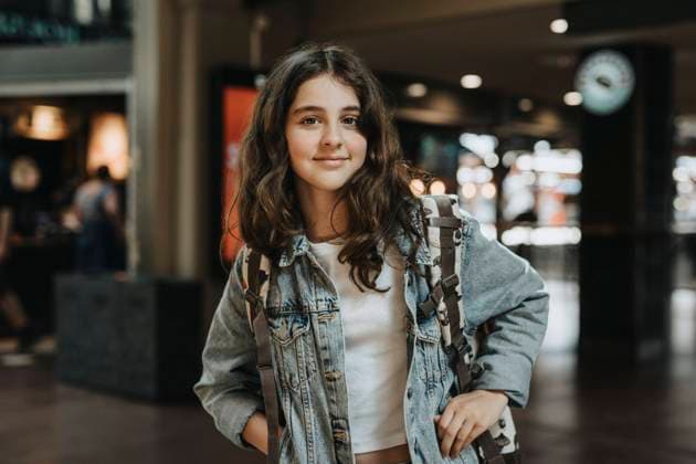 Portrait of smiling girl wearing denim jacket while standing at station Sweden, Gothenburg, model released Copyright: xMaskotx , MA104111 MA104111