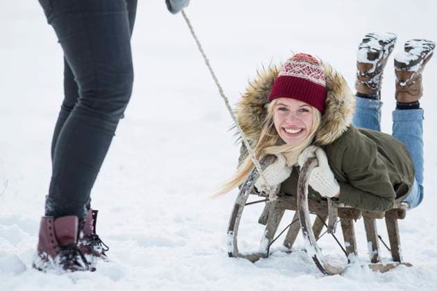 Two teenage girls with slide in snowy landscape in winter, Bavaria, Germany Germany CR_EDDR160117-02013-01 ,model released, Symbolfoto