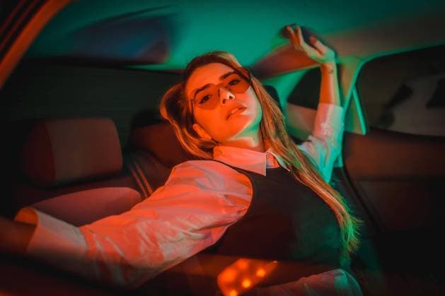 Creative Highlights Symbolbilder Stadtfotografie mit roten und grünen Neons auf dem Rücksitz eines Autos einer jungen blonden kaukasischen Frau mit Herzbrille *** City photography with Red and Greens neons at the Back seat one Cars a Boys blonde Caucasian Woman with Heart glasses Copyright: imageBROKER/UnaixHuizi ibxuhu09693644.jpg ,model released, Symbolfoto ,property released