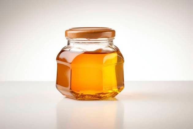 A clear top view of a honey jar, perfectly isolated on a white background with copy space. Top View Honey Jar Isolated Copyright: xFilippoxCarlotx COMM (13955)