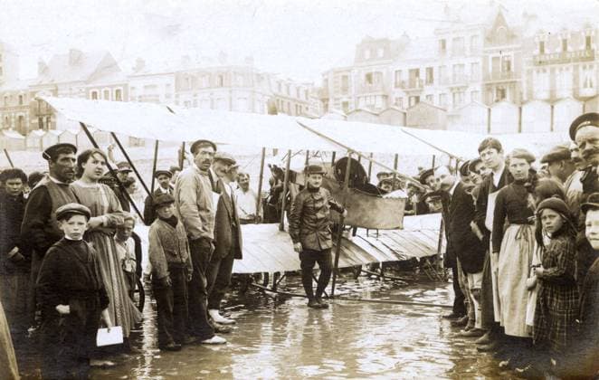 RECORD DATE NOT STATED French Caudron biplane after beach landing French Caudron single-seater biplane after a beach landing, with the pilot and a large crowd of onlookers, with a Grand Hotel in the top right. Date: circa 1912  Copyright: Gemini Picture No. 12152521