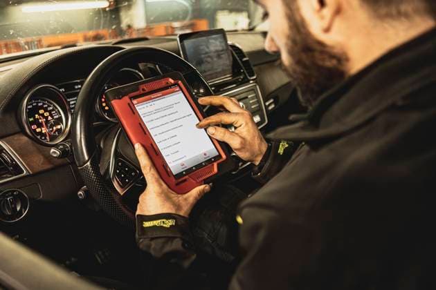 Mechanic Running Diagnostics on Modern Car Computer A mechanic s hands use a diagnostic tool to troubleshoot a modern car s computer system in a garage. Mechanic Running Diagnostics on Modern Car Computer Copyright: xfilippoxcarlotx EDITT (239)