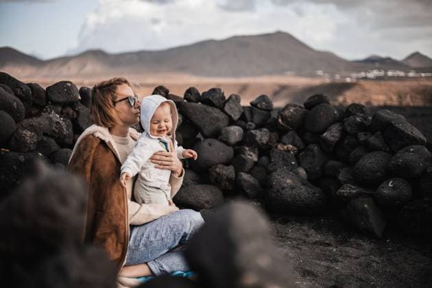 Mother enjoying winter vacations playing with his infant baby boy son on black sandy volcanic beach of Janubio on Lanzarote island, Spain on windy overcast day. Family travel vacations concept. Mother enjoying winter vacations playing with his infant baby boy son on black sandy volcanic beach of Janubio on Lanzarote island, Spain on windy overcast day. Family travel vacations concept ,model released, Symbolfoto Copyright: xZoonar.com MatejxKastelicx 20556229 ,model released, Symbolfoto ,property released