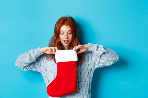 Winter holidays and gifts concept. Funny redhead girl looking inside Christmas stocking and smiling happy, receiving xmas present, standing against blue background., model released, , 41251796.jpg, woman, girl, redhead, female, women, teenager, teen, student, young, background, lifestyle, red, ginger, face, portrait, beautiful, adult, attractive, isolated, people, smile, happy, hairstyle, style, youth, freckles, natural, lovely, shopping, winter, holidays, blue, sweater, cozy, promo, Christmas, merry, New Year, offer, casual, modern, presents, gift, holding, surprised, amazed, disbelief, sock, stocking, open RECORD DATE NOT STATED