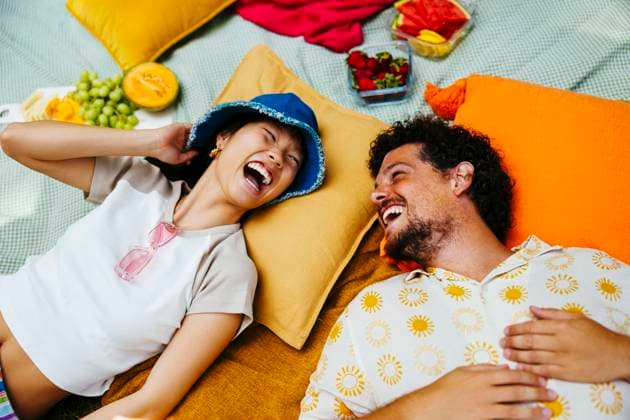 Happy friends enjoying together and lying on picnic blanket model released, Symbolfoto, EBSF03762