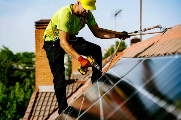 Engineer wearing hardhat using drill machine to install solar panel model released, Symbolfoto, JJF01138