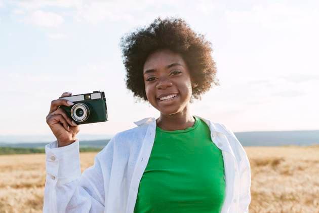 Happy young woman holding camera model released, Symbolfoto, AAZF01087