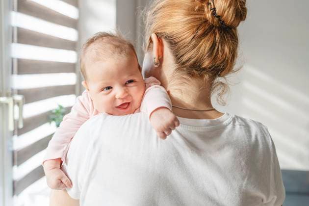 Smiling newborn baby resting on mother s shoulder at home model released, Symbolfoto property released, IHF01761