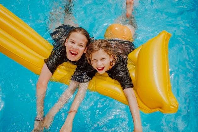 Cheerful girls having fun in swimming pool model released, Symbolfoto property released, MDOF01584