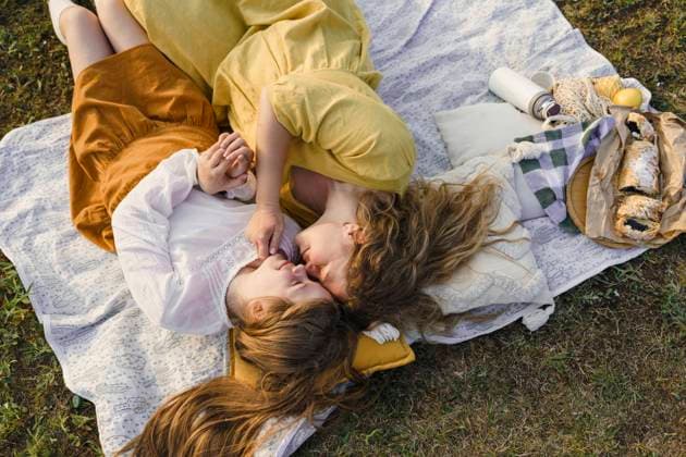 Mother and daughter rubbing noses and lying on picnic blanket model released, Symbolfoto, VBUF00400