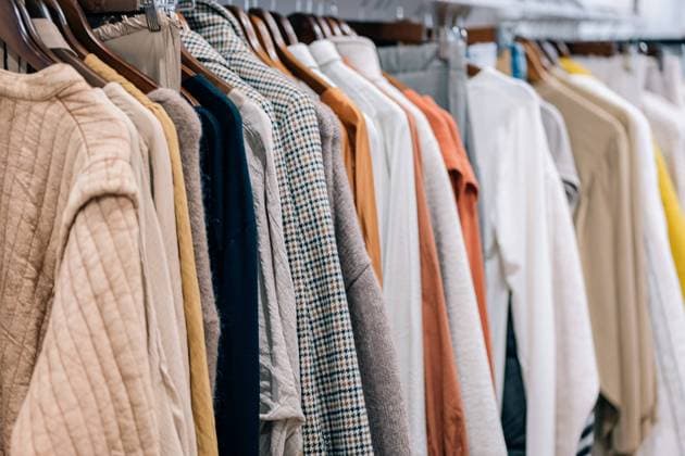 Close-up view of a variety of shirts, jackets and sweaters hung on wooden hangers in a store display. Model Released HodeiUnzueta_ID17056_519766_001 Copyright: xHodeixUnzuetax RECORD DATE NOT STATED