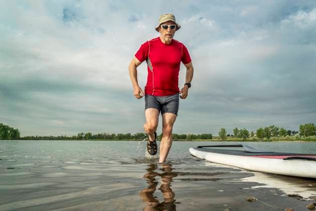 senior paddler with stand up paddleboard senior paddler with stand up paddleboard on, lake shore in northern Colorado with an early summer scenery ,model released, Symbolfoto Copyright: xZoonar.com MarekxUliaszx 9287228 ,model released, Symbolfoto ,property released