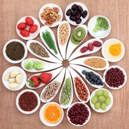 Large health food selection in white porcelain bowls and dishes over papyrus background. Copyright: MarilynxBarbone 32117658