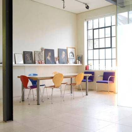 Colourful Arne Jacobsen style chairs at table in contemporary dining room Colourful Arne Jacobsen style chairs at table in contemporary dining room, Credit:David George Avalon UNITED KINGDOM  Copyright: xDavidxGeorgex xAvalonx 0512755116