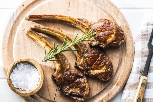 Grilled lamb chops on cutting board. Grilled lamb chops on wooden cutting board. Top view. Copyright: xZoonar.com JIRIxHERAx 16423304