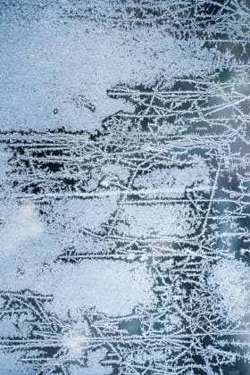 A cold winters morning Frost on a glass window with rising sun glowing orange Copyright: xtimxkahanex tkah20230116831-17