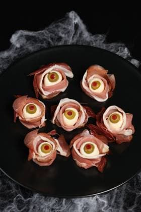 Original Halloween snacks. Eyeballs cooked from ham with mozzarella, olives stuffed with red pepper , 36146628.jpg, jerked beef, Halloween, Cured, Ham, gammon, Eye, Eyeball, Cheese, Mozzarella, Olive, Decor, Authenticity, uncooked, celebratory, festive, holiday, feast, party, bites, Smorgasbord, portion, luncheon, brunch, lunch, dinner, food, appetizer, snack, healthy, piece, cut, slice, Side, dish, Side dish, meal, dishes, macrobiotic, eating, seasoning, Nutrition, Nourishing, Nourishment, hind quarter, Idea, concept, originality, delicacy, horribly, stand-up meal, canapes RECORD DATE NOT STATED
